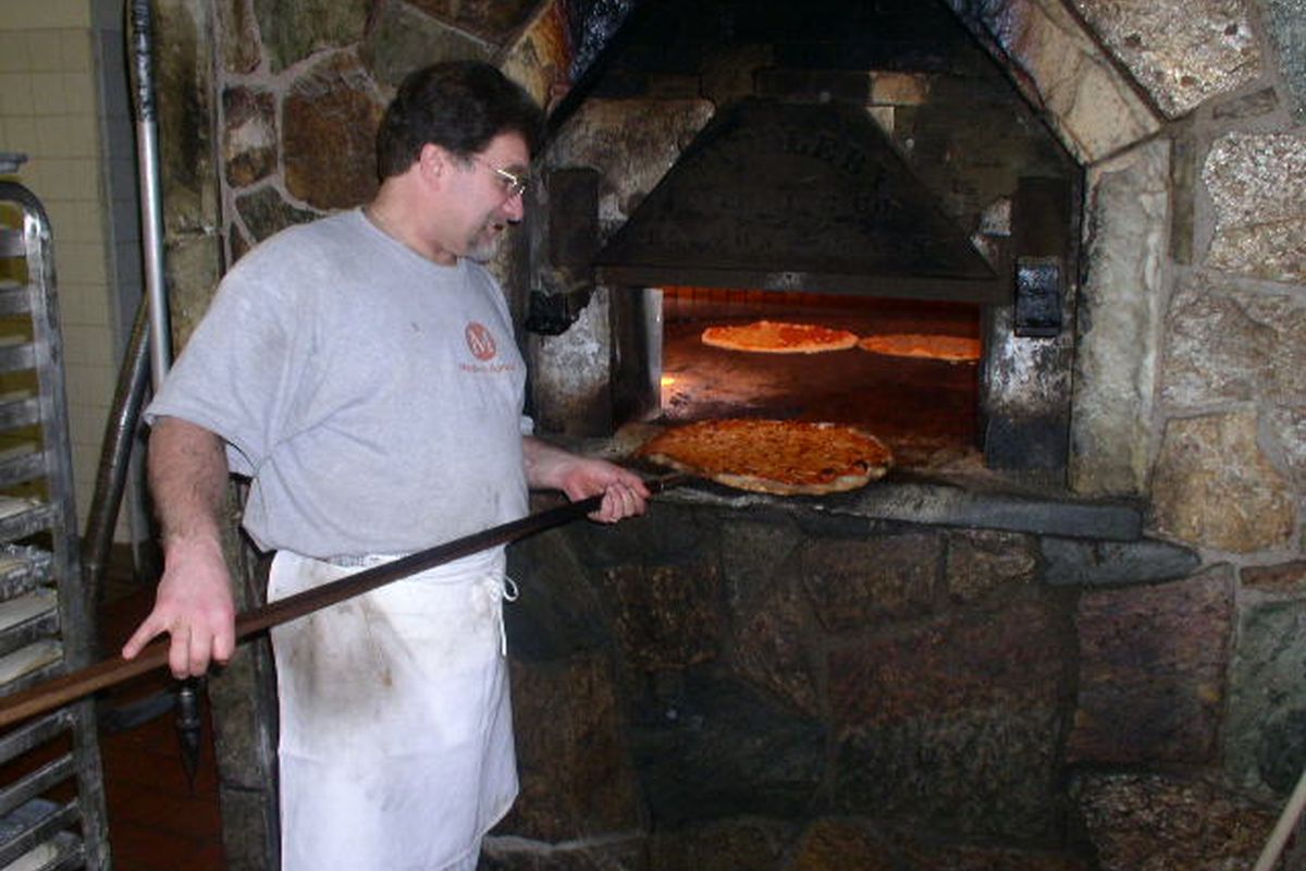 Pulling a pie from the deck oven